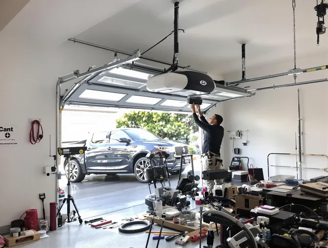 Avon Lake Garage Door Repair specialist installing smart garage door opener system in Avon Lake home